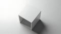 Minimalist white cube shelf casting a soft shadow on a clean surface Royalty Free Stock Photo