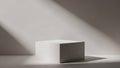 Minimalist white cube on a white surface with dramatic diagonal light and shadow casting a stark contrast Keywords Royalty Free Stock Photo
