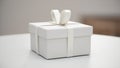 Minimalist white gift box with ribbon on a clean table in soft studio light Royalty Free Stock Photo