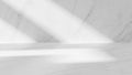 Minimalist white marble studio with diagonal light beams casting shadows on the floor and wall Keywords: studio Royalty Free Stock Photo