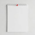 Minimalist white notebook with red button on a neutral background Royalty Free Stock Photo