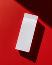 Minimalist White Product Box on Bold Red Surface with Dramatic Shadow and Contemporary Style Aesthetic Royalty Free Stock Photo