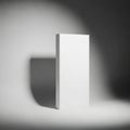 Minimalist white rectangular box illuminated by spotlight with subtle shadow on textured surface Royalty Free Stock Photo