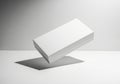 Minimalist white rectangular object casting a shadow on a plain surface isolated on white background Royalty Free Stock Photo