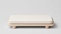 A minimalist white rectangular object on a light brown wooden base. Royalty Free Stock Photo