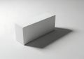 Minimalist white rectangular prism casting a long shadow Royalty Free Stock Photo