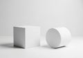 A minimalist white setting features a cube and a cylinder on a flat Royalty Free Stock Photo