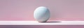 A minimalist white sphere resting on a pastel pink ledge under soft lighting Royalty Free Stock Photo