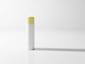 Minimalist white and yellow cylindrical object on white surface Royalty Free Stock Photo