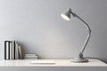 Minimalist workspace design featuring a sleek grey lamp and curated book collection against a simplistic wall