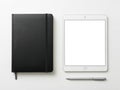 A minimalist workspace featuring a notebook, tablet, and stylus pen isolated on white background Royalty Free Stock Photo