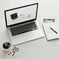 Minimalist workspace featuring an open laptop displaying an image of itself, Royalty Free Stock Photo
