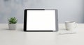 Tablet Mockup on Desk with Coffee and Plant Royalty Free Stock Photo