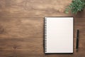 Minimalist workspace Top view of a notebook on wooden flooring