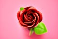 Minimalistic of an artificial red rose image photographed in studio isolated on pink