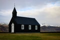 Minimalistic black Budir church in the countryside of Iceland