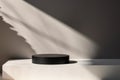 Minimalistic Black Cylinder on White Platform Royalty Free Stock Photo
