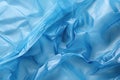 Minimalistic blue texture of transparent wrinkled plastic. Crumpled wrinkled plastic cellophane. Reflects light and shadow on the