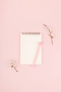 Minimalistic card mockup with empty open white notebook, blossom cherry flower branch on pink  background. Flat lay, top view, Royalty Free Stock Photo