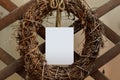 Minimalistic card mockup with old wreath of herbs. Rystic style. Vintage wooden background