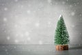 Minimalistic christmas composition with decorative fir tree,wooden sledge ,snow on grey background