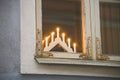 Minimalistic Christmas decoration in Europe a candlestick for seven candles by the window. Royalty Free Stock Photo