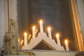 Minimalistic Christmas decoration in Europe a candlestick for seven candles by the window. Royalty Free Stock Photo