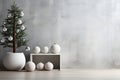 Minimalistic Christmas interior with grey concrete wall and a Christmas tree with big baubles