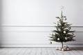 Minimalistic Christmas interior mockup with white wall with a sleek Christmas tree