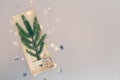 Minimalistic Christmas tree made of evergreen fir plant decorated with angel and luminous garland on white paper Royalty Free Stock Photo