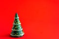 Minimalistic Christmas tree made of evergreen fir plant on red background. Christmas, new year concept. Flat lay Royalty Free Stock Photo