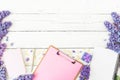 Minimalistic composition with clipboard, notebook, lilac flowers, gift box and accessories on wooden background. Flat lay, top vie Royalty Free Stock Photo