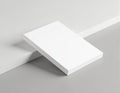 Minimalistic composition features pristine white notepad stack on soft gray surface. Clean blank paper stationery offers simple, Royalty Free Stock Photo