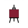 Minimalistic design featuring a black easel holding a deep maroon canvas. The easel Royalty Free Stock Photo
