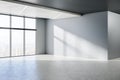 Minimalistic empty concrete room interior with windows, city view, sunlight and shadows. Royalty Free Stock Photo