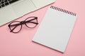 Minimalistic flat lay composition of laptop, glasses and jotter Royalty Free Stock Photo