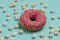 Minimalistic food still life. Glazed donut with marshmallows on blue pastel background. Vanilla color trend. Pop Art Royalty Free Stock Photo