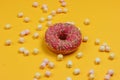 Minimalistic food still life. Glazed donut with marshmallows on yellow background Royalty Free Stock Photo