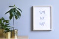 Minimalistic home interior with mock up photo frame on the brown table with composition of cacti and succulents. Royalty Free Stock Photo