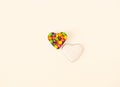 Minimalistic isolated shaped heart bowl with colorful candies on bright background.