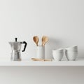 A minimalistic kitchen scene on a white shelf features a silver stovetop espresso Royalty Free Stock Photo