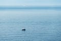 landscape with a fishing boat in the endless blue calm sea