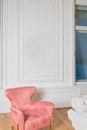 Minimalistic and luxury pastel pink home interior with velvet design armchair, big window.classical style Armchair in