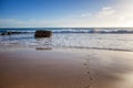minimalistic marine background, blue ocean, sandy beach, footprints in the sand Royalty Free Stock Photo