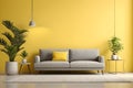 Minimalistic modern interior design with grey sofa with pillow and bright yellow clear wall with plants Royalty Free Stock Photo