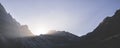 Minimalistic mountain landscape, the sun\'s rays shine from behind the mountain, a dark mountain at sunset in the evening Royalty Free Stock Photo