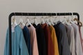 Minimalistic rack with linen colourful clothes on white studio background.