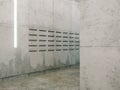 Minimalistic room with concrete surfaces ( post boxes view )