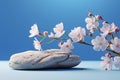 Minimalistic scene stone with flowers on a light blue background