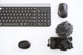 A minimalistic set of vlogger: camera with mic, mouse, keyboard, and earphones Royalty Free Stock Photo